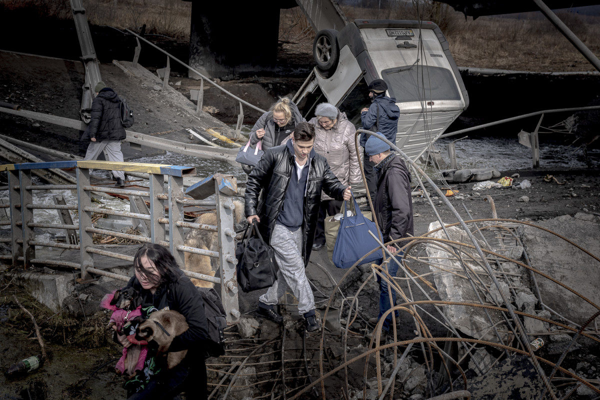 A family with three kids gather at the evacuation point in Romanivka fleeing the combats